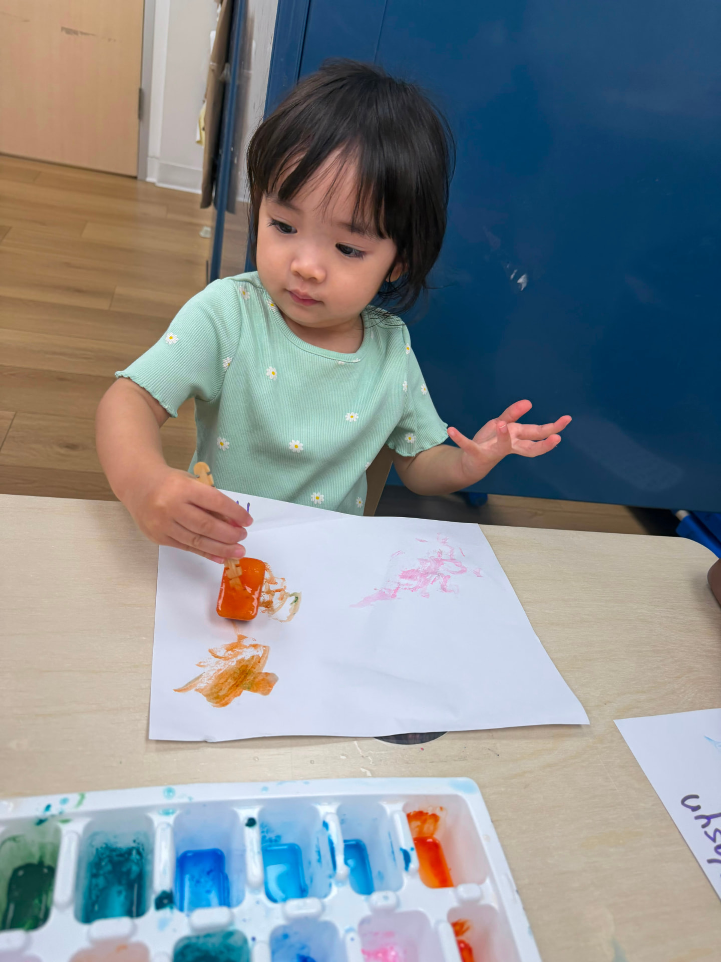 Toddler participating in a classroom activity